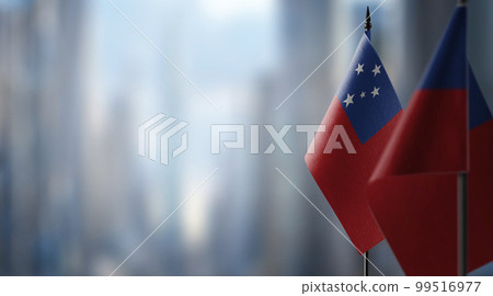 Small flags of the Samoa on an abstract blurry background 99516977