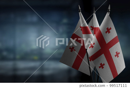 A small Georgia flag on an abstract blurry background A small Georgia flag on an abstract blurry background 99517111