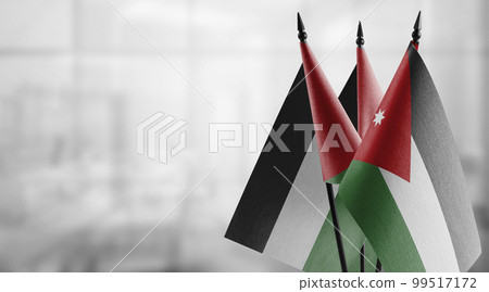 Small flags of the Jordan on an abstract blurry background Small flags of the Jordan on an abstract blurry background 99517172