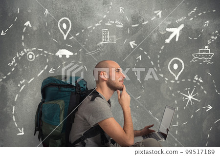 Explorer plans a new travel with his laptop 99517189