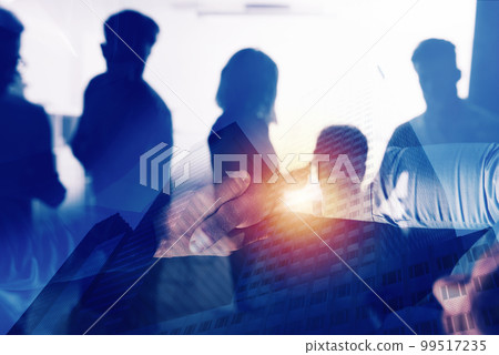 Handshaking business person in office. concept of teamwork and partnership. double exposure 99517235
