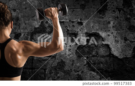 Athletic woman training biceps on grunge background Athletic woman training biceps on grunge background 99517383