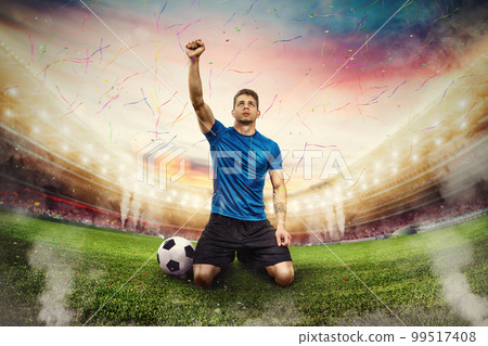 Football player exults in a stadium with audience 99517408