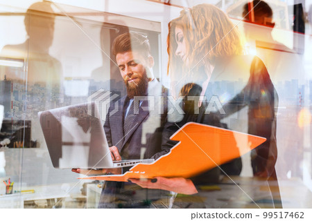 Business people work together in office with a laptop as a team and partner Business people work together in office with a laptop as a team and partner 99517462
