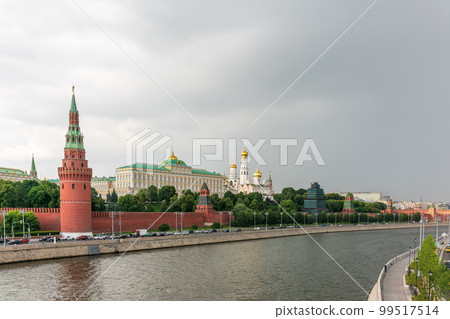 View of Kremlin with Vodovzvodnaya tower, Grand Kremlin Palace from repaired Bolshoy Kamenny Bridge in Moscow city on sunny summer day. Cruise ship sails on the Moscow river 99517514