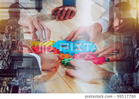 Business team connect pieces of colorful gears like a teamwork and partners Business team connect pieces of colorful gears like a teamwork and partners 99517780