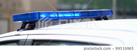 Closeup of blue lights on roof of police car 99519965