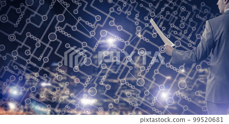 Rear view of businessman against night cityscape background and technology concept 99520681