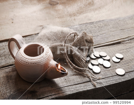 Pouch with silver coins on a wooden table Pouch with silver coins on a wooden table 99520994