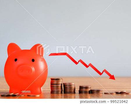 red arrow down graphic. Falling savings or bankruptcy and loss of investment.on gray background. Copy space for text savings in piggy bank and coin stairs 99521042