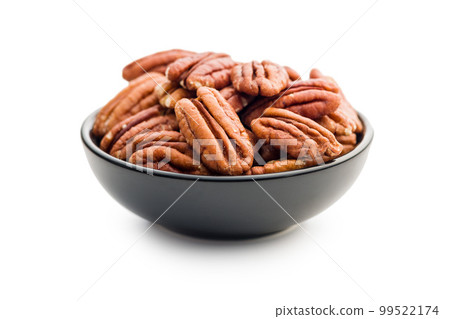 Peeled pecan nuts in bowl isolated on white background. 99522174