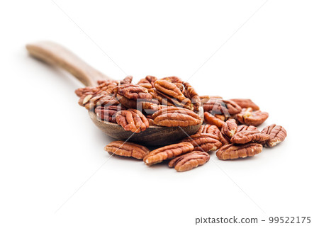 Peeled pecan nuts in wooden spoon isolated on white background. 99522175