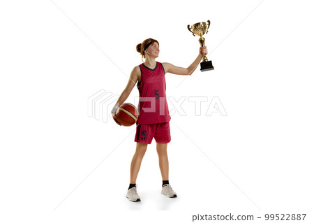 Winning game. Teen girl, basketball player posing with trophy, award isolated over white studio background. Concept of professional sport and hobby Winning game. Teen girl, basketball player posing with trophy, award isolated over white studio background. Concept of professional sport and hobby 99522887