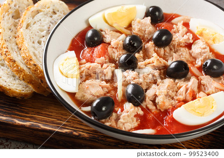 Traditional Murcian Salad Mojete made of tomato, canned tuna, black olive, boiled egg and onion closeup on the plate. Horizontal Traditional Murcian Salad Mojete made of tomato, canned tuna, black olive, boiled egg and onion closeup on the plate. Horizontal 99523400