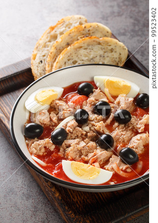 Murcian Salad La ensalada murciana with tomato, canned tuna, black olive, egg and onion closeup on the plate. Vertical Murcian Salad La ensalada murciana with tomato, canned tuna, black olive, egg and onion closeup on the plate. Vertical 99523402