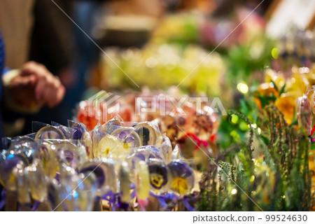 In Frame Of Caramel On Stick With Pattern Of Yellow - Purple Flowers. Small Depth Of Field. In Frame Of Caramel On Stick With Pattern Of Yellow - Purple Flowers. Small Depth Of Field. 99524630