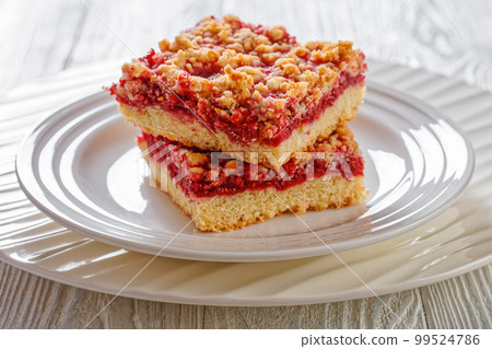 Raspberry Crumble Bars on white plate, top view 99524786