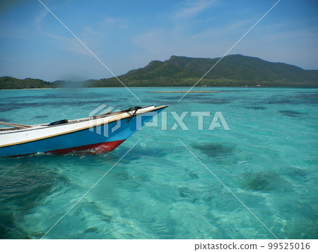 Wooden boat in the ocean Wooden boat in the ocean 99525016