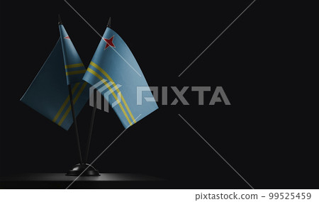 Small national flags of the Aruba on a black background 99525459
