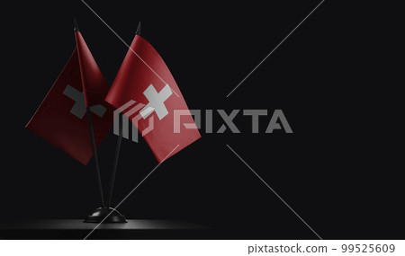 Small national flags of the Switzerland on a black background 99525609