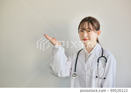 Young female doctor posing this way Young female doctor posing this way 99526122