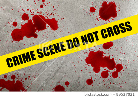 Yellow police barricade tape over blood stains 99527021