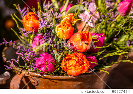 Different flowers and seedlings near the florist flower shop entrance, spring time, easter concept Different flowers and seedlings near the florist flower shop entrance, spring time, easter concept 99527424