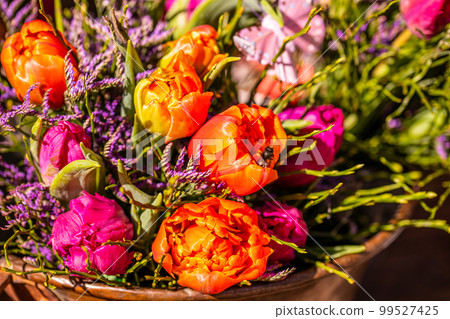 Different flowers and seedlings near the florist flower shop entrance, spring time, easter concept Different flowers and seedlings near the florist flower shop entrance, spring time, easter concept 99527425