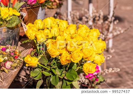 Different flowers and seedlings near the florist flower shop entrance, spring time, easter concept Different flowers and seedlings near the florist flower shop entrance, spring time, easter concept 99527437