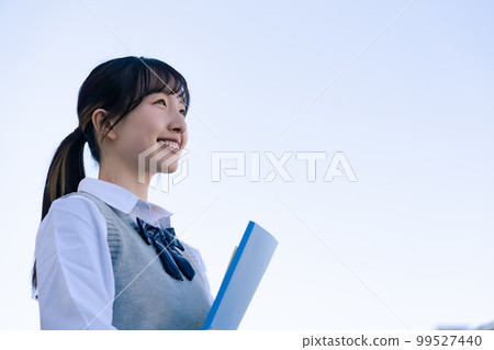 High school girl in uniform looking far away outside High school girl in uniform looking far away outside 99527440