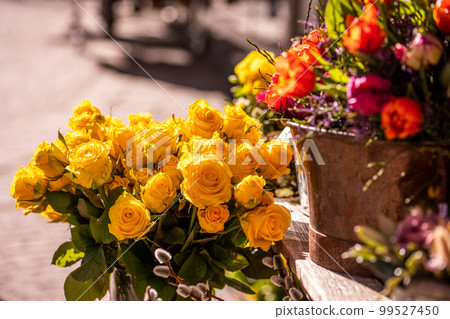 Different flowers and seedlings near the florist flower shop entrance, spring time, easter concept Different flowers and seedlings near the florist flower shop entrance, spring time, easter concept 99527450