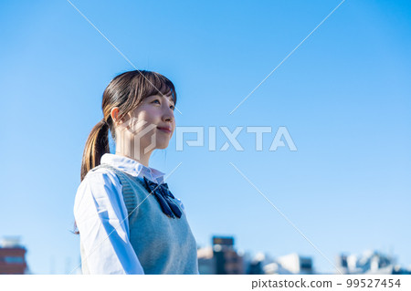 High school girl in uniform looking far away outside High school girl in uniform looking far away outside 99527454