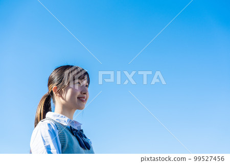High school girl in uniform looking far away outside High school girl in uniform looking far away outside 99527456