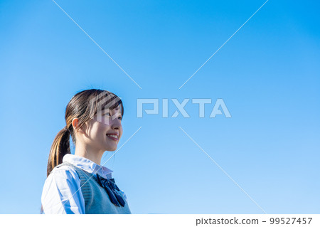 High school girl in uniform looking far away outside 99527457