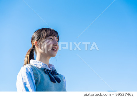 High school girl in uniform looking far away outside High school girl in uniform looking far away outside 99527462