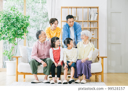 Three-generation family relaxing in the living room Three-generation family relaxing in the living room 99528157