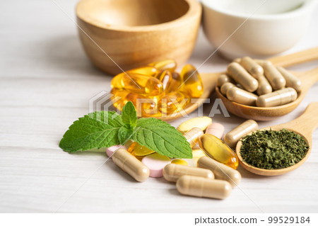 Alternative medicine herbal organic capsule with vitamin E omega 3 fish oil, mineral, drug with herbs leaf natural supplements for healthy good life. 99529184