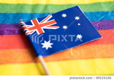 Australia flag on rainbow background flag symbol of LGBT gay pride month social movement rainbow flag is a symbol of lesbian, gay, bisexual, transgender, human rights, tolerance and peace. Australia flag on rainbow background flag symbol of LGBT gay pride month social movement rainbow flag is a symbol of lesbian, gay, bisexual, transgender, human rights, tolerance and peace. 99529186