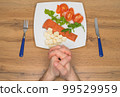 A man prays before meal. Hands close-up. Healthy food. Keto diet. Selective focus. 99529959