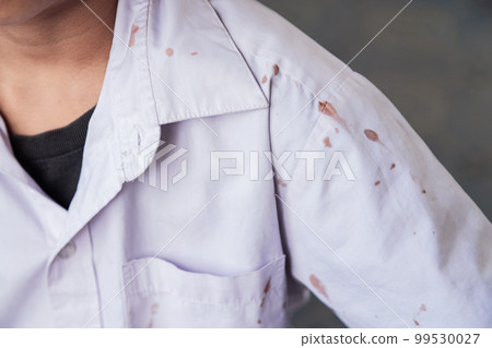 chocolate stain on white shirt of kid from eating in daily life for cleaning concept idea 99530027