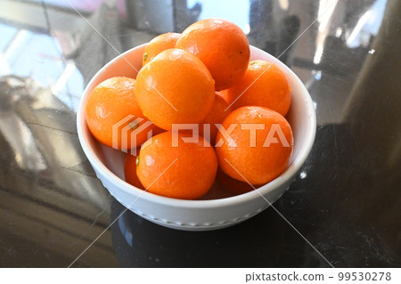 Kumquats piled up in a bowl Kumquats piled up in a bowl 99530278