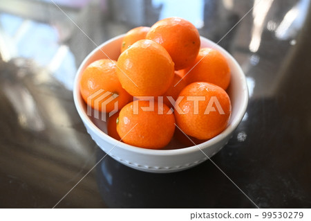 Kumquats piled up in a bowl Kumquats piled up in a bowl 99530279