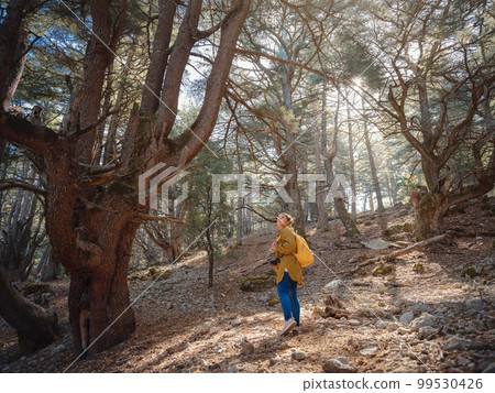 caucasian woman enjoys being in nature, 99530426