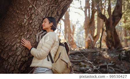 woman enjoys nature, beautiful forest in mountains 99530427