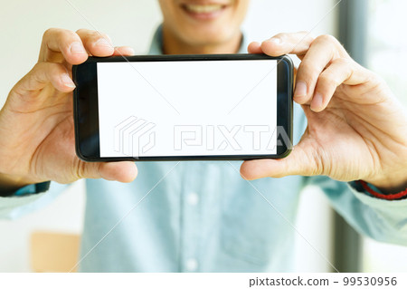 Man holding smartphone in hand. Business man showing smartphone. 99530956