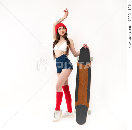 sexy girl in a fashionable red hat with a longboard on a white background 99531306