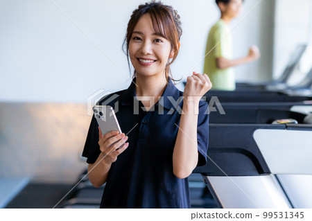 gym instructor with smartphone 99531345