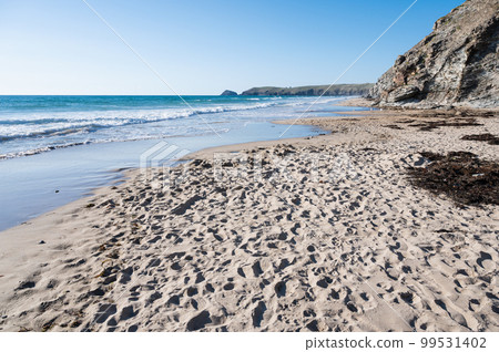 Sandy beach of Perranporth in West Cornwall, South West England. View of the beach, blue sea and cliffs. Selective focus 99531402