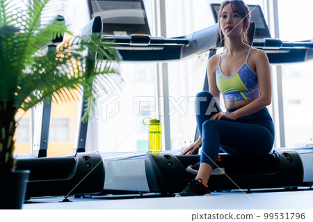 Young woman training in a sports gym Young woman training in a sports gym 99531796