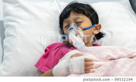 Sick boy inhalation therapy by the mask of inhaler.  99532194